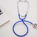 A blue stethoscope next to a laptop. - Salt Lake City Healthcare Consultant
