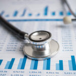 stethoscope on chart and graph paper | 8 Proven Strategies to Streamline Revenue Cycle Management in Your Practice